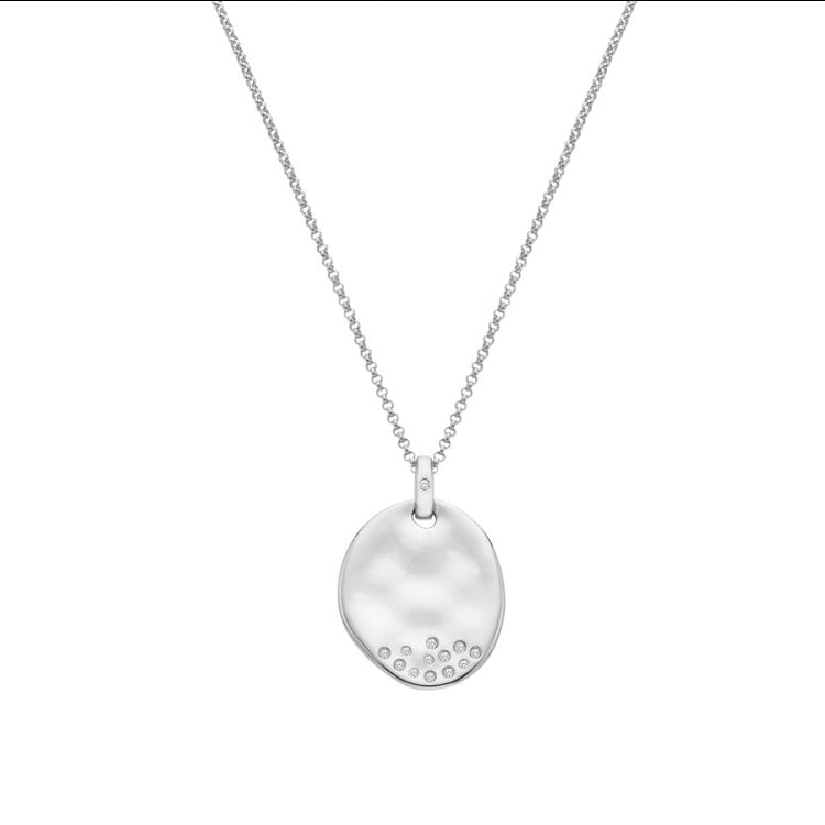 Silver necklace with a round pendant on a white background