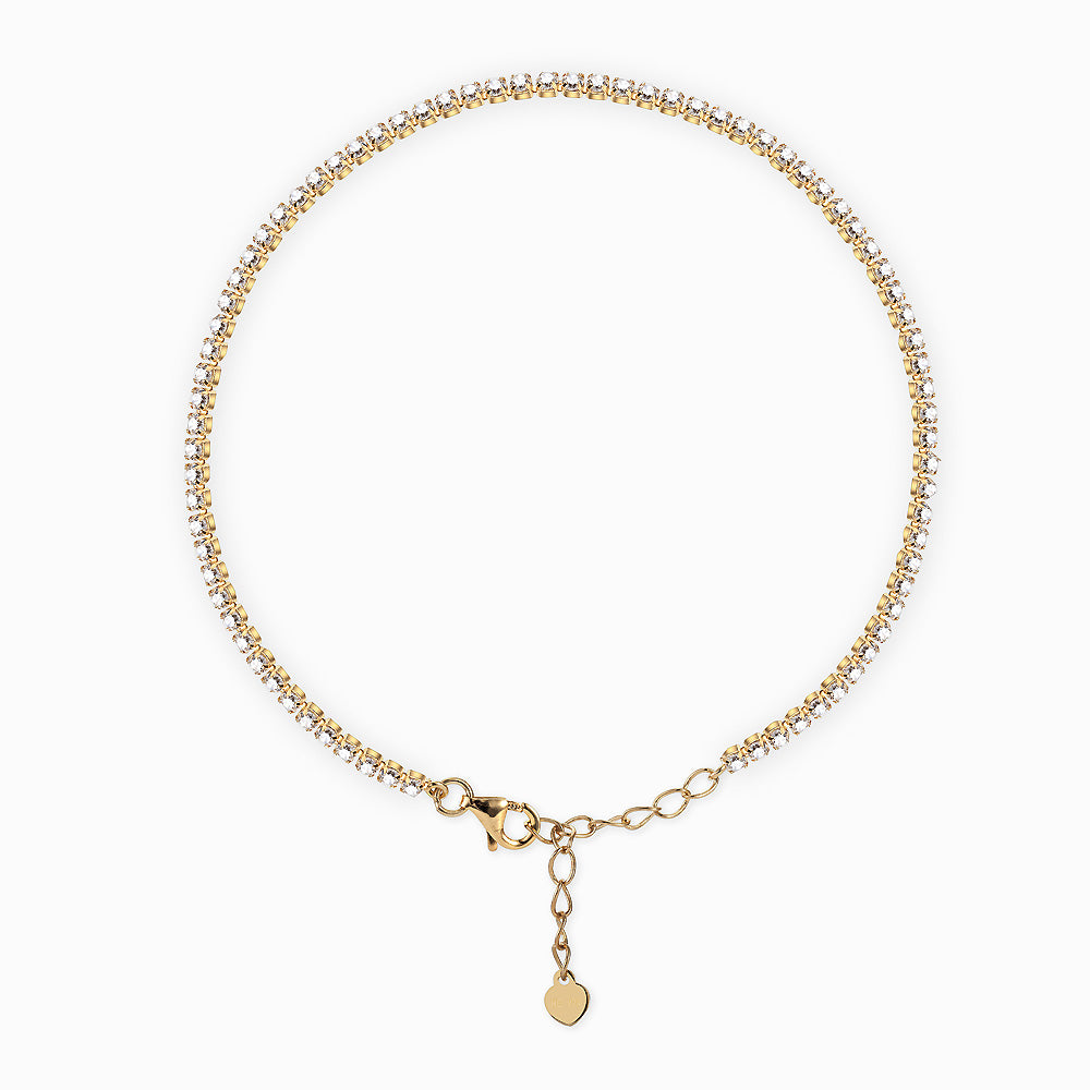 Gold bracelet with a heart-shaped charm on a white background