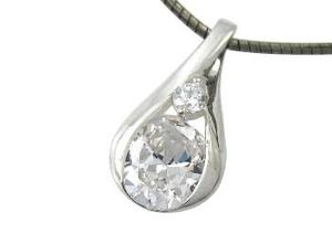 Teardrop-shaped silver pendant with a clear gemstone on a white background