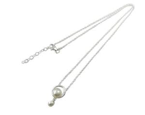 Silver necklace with a single pearl on a white background