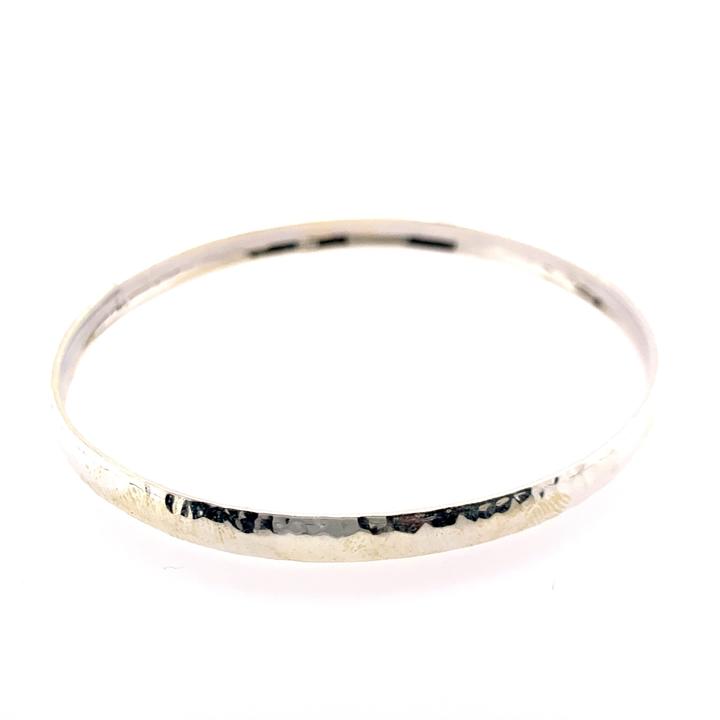 Gold bangle on a white background