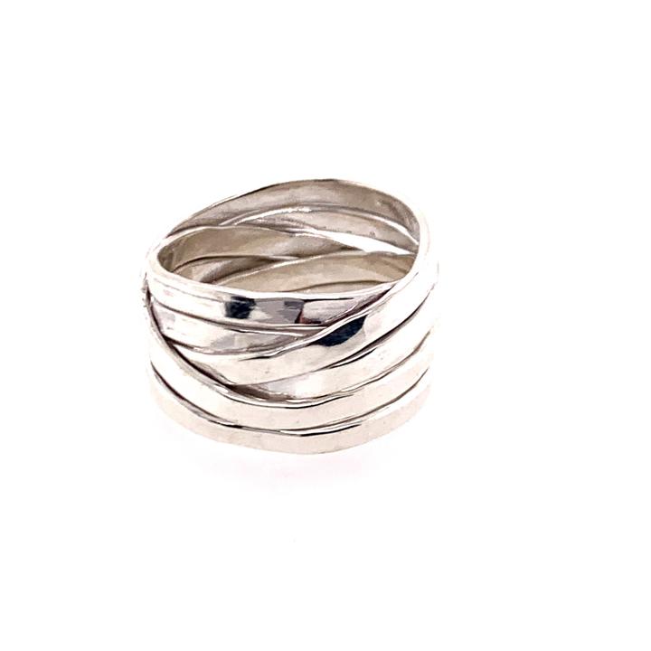 Silver ring with wavy design on a white background