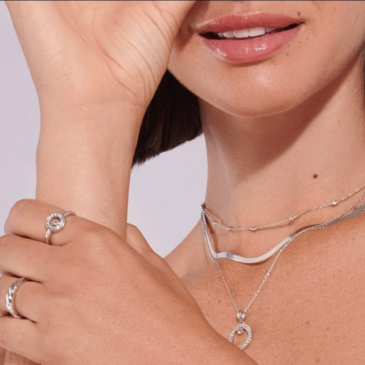 HD Intermittent Oval Necklace worn with other necklaces and rings