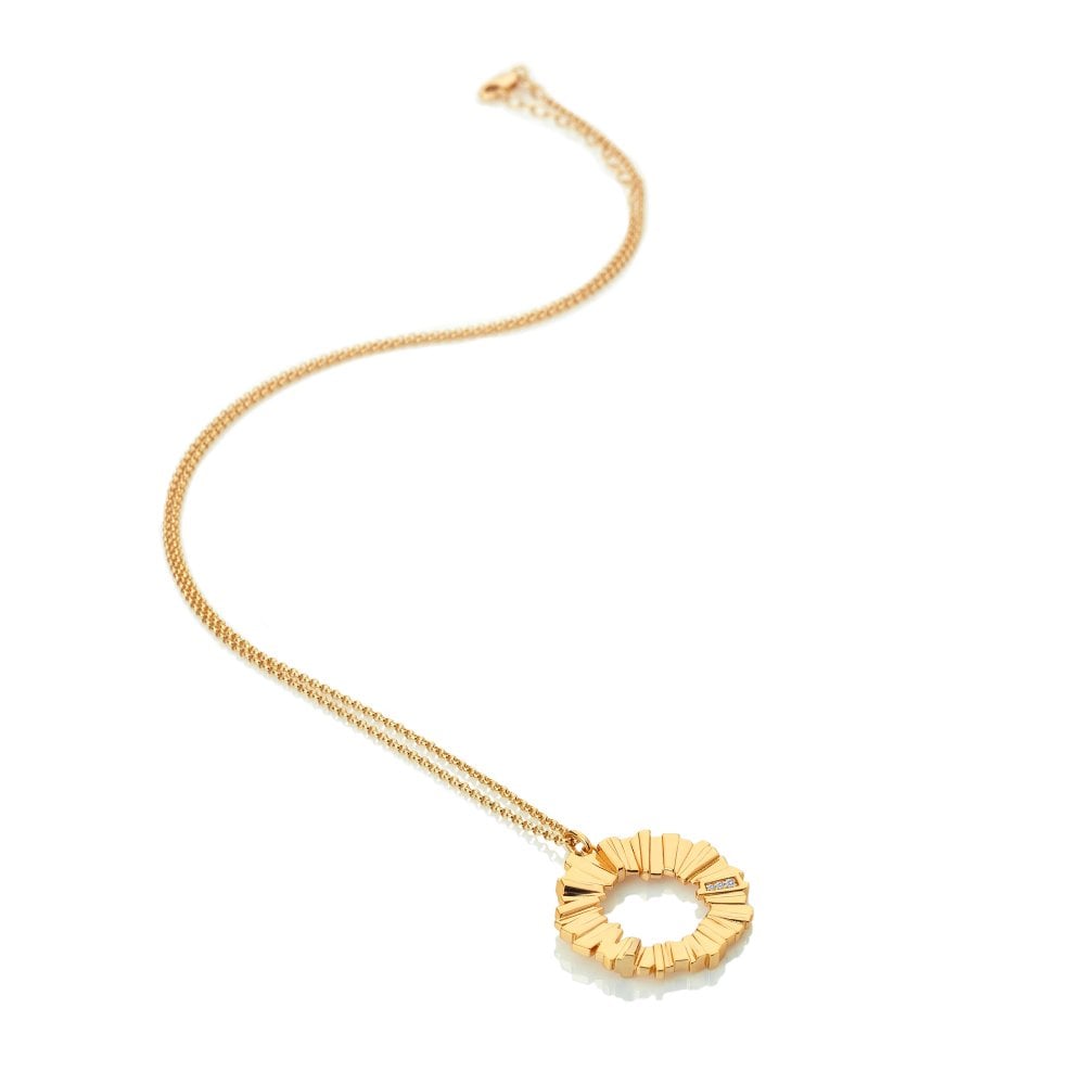 Gold necklace with a circular pendant on a white background