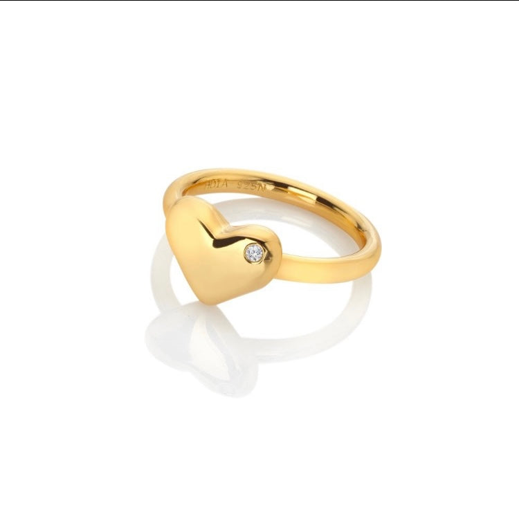Gold ring with a heart-shaped design and diamond on a white background
