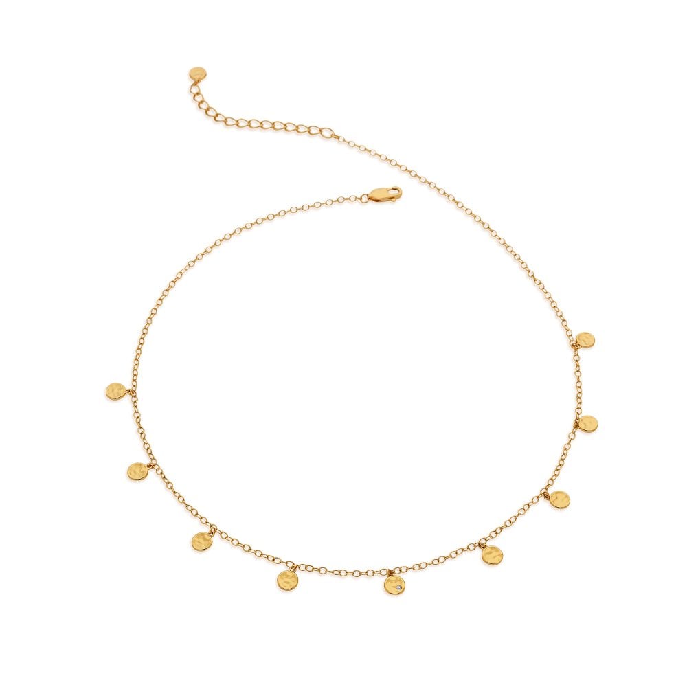 Gold necklace with small round pendants on a white background