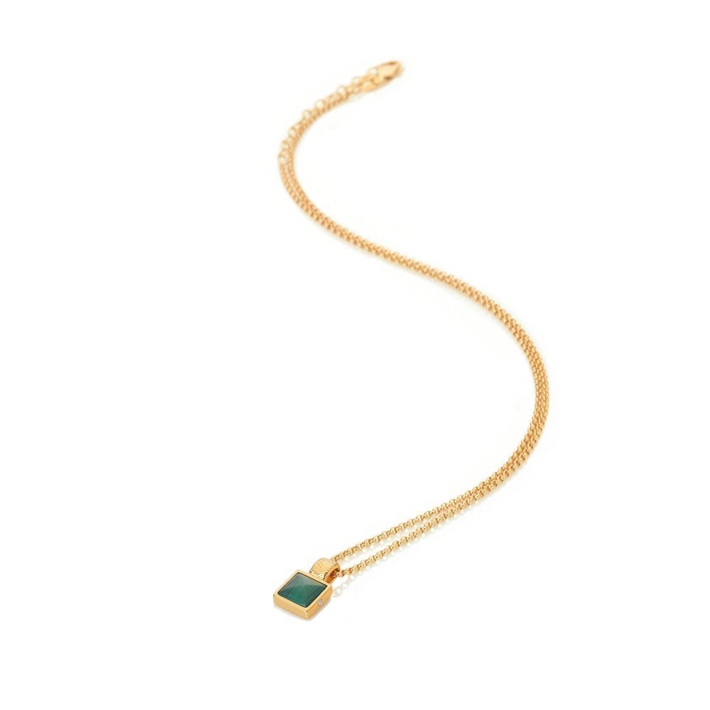 Gold necklace with a green pendant on a white background
