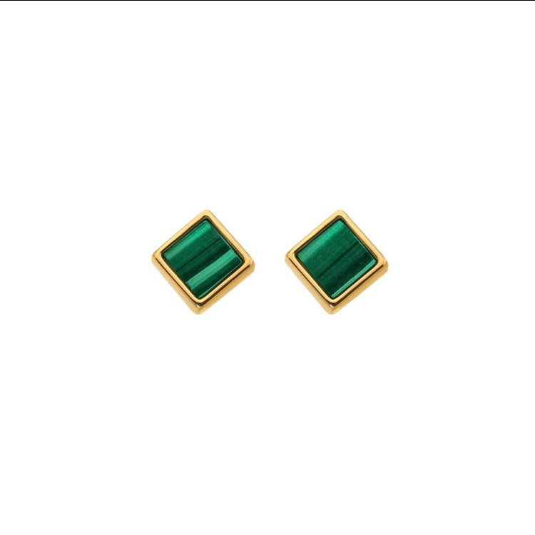 Gold square earrings with green stones on a white background