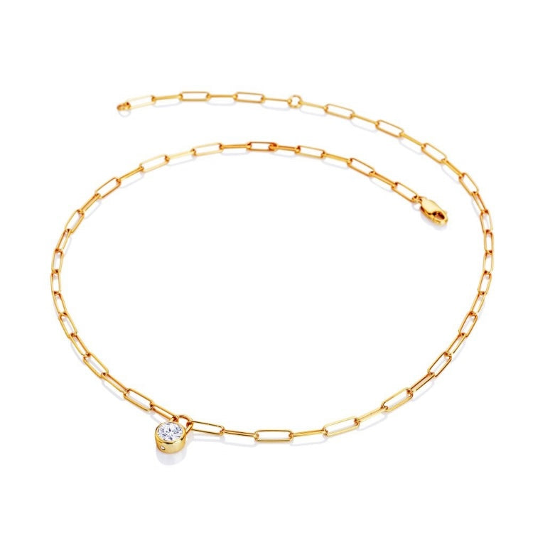 Gold chain necklace with a small round pendant on a white background