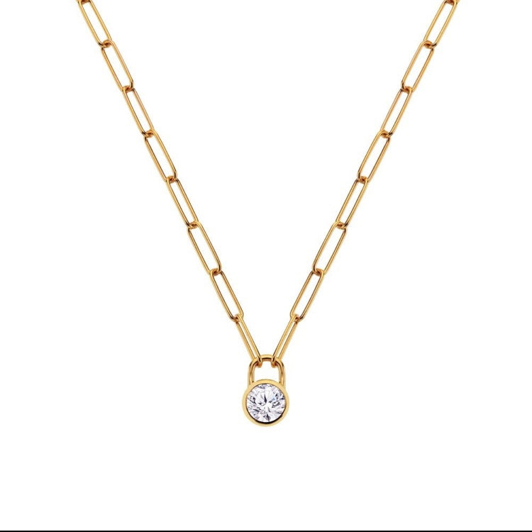 Gold chain necklace with a round pendant on a white background
