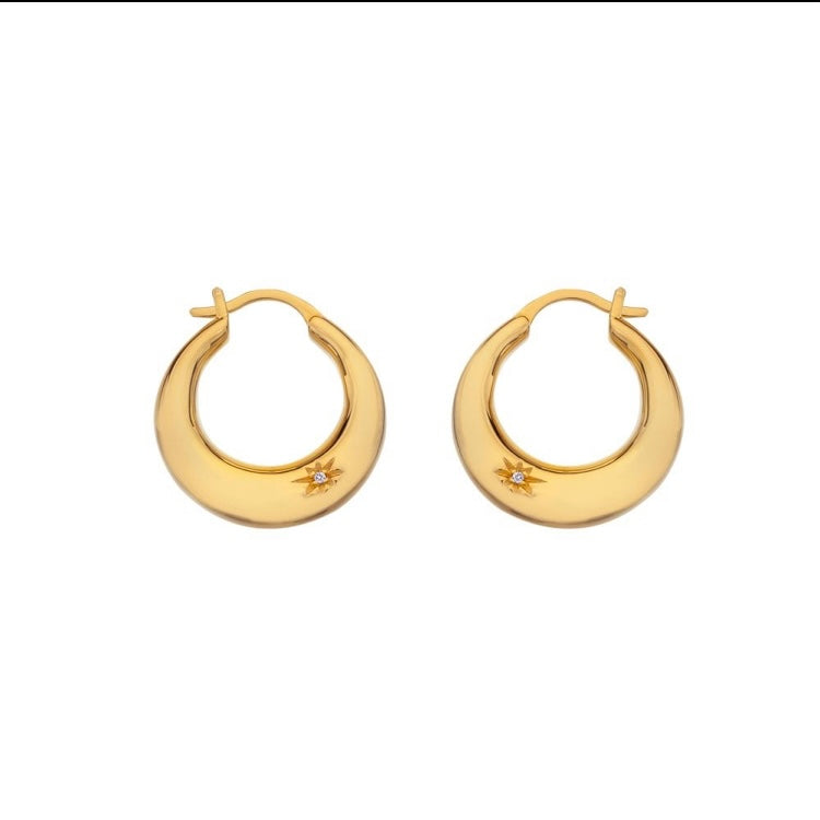 Pair of gold hoop earrings on a white background