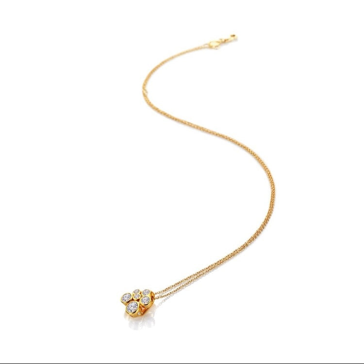 Gold necklace with a heart-shaped pendant on a white background