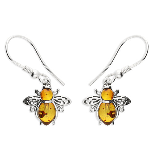 Silver earrings with amber-colored stones on a white background