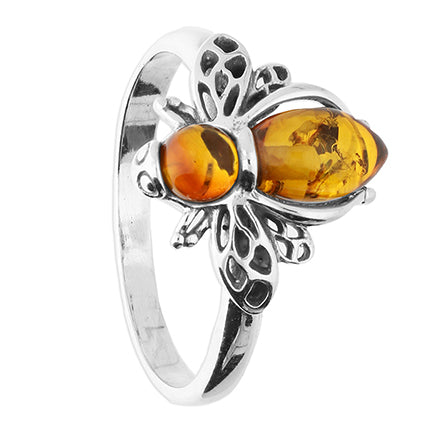 Silver ring with amber stones on a white background