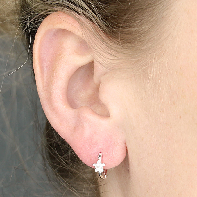 Sterling Silver Cubic Zirconia Star Huggie Earrings in the ear