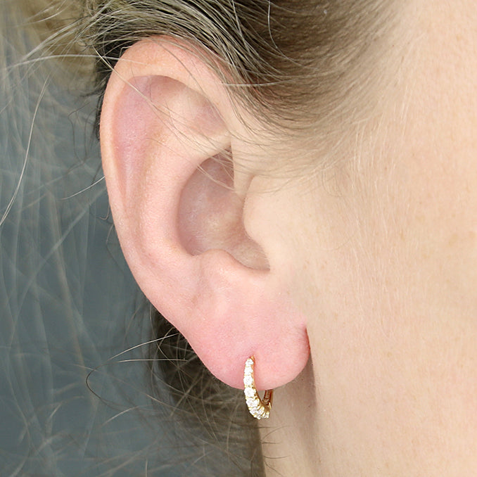Sterling Silver Gold Plated Graduated Cubic Zirconia Huggie Earrings in the ear