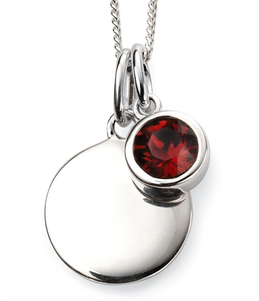 Silver pendant with a red gemstone on a white background